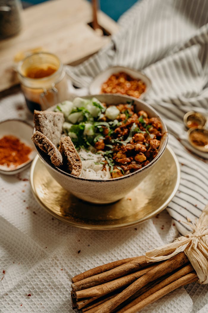 Services A delicious, healthy vegan bowl featuring chickpeas, rice, cucumbers, and spices. Perfect for a nutritious meal.